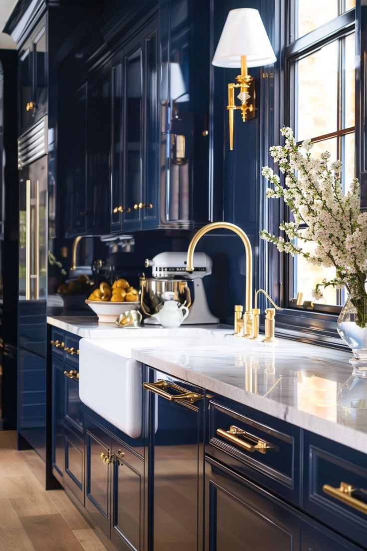 glossy navy blue kitchen cabinets with brass hardware